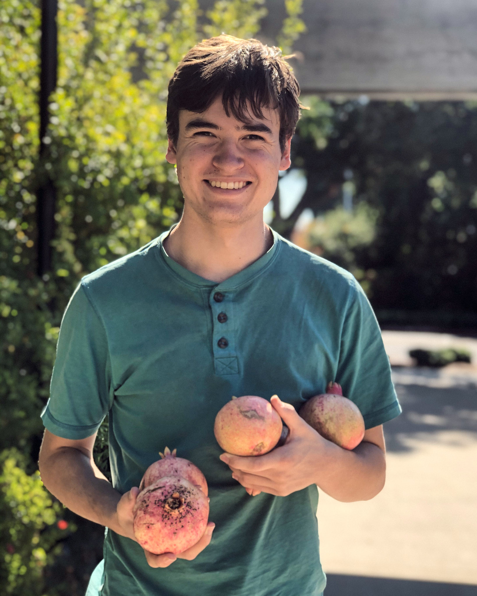 Graceson holding some pomegranates